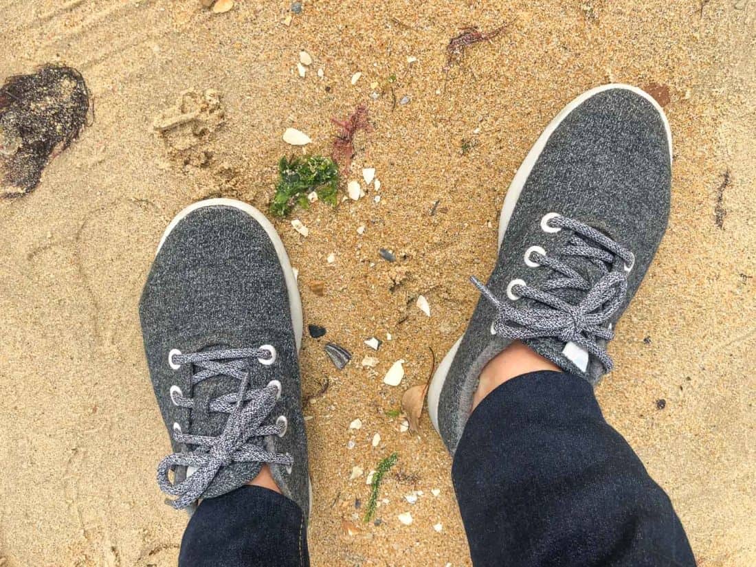 Allbirds Wool Runners in natural grey worn on the beach