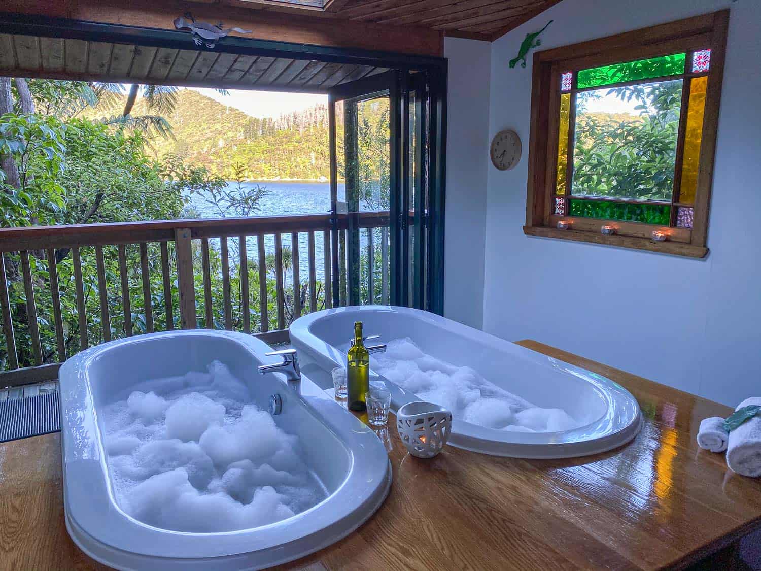 Side by side bubble baths in the private bathhouse at Lochmara Lodge in the Marlborough Sounds, Queen Charlotte Track, New Zealand