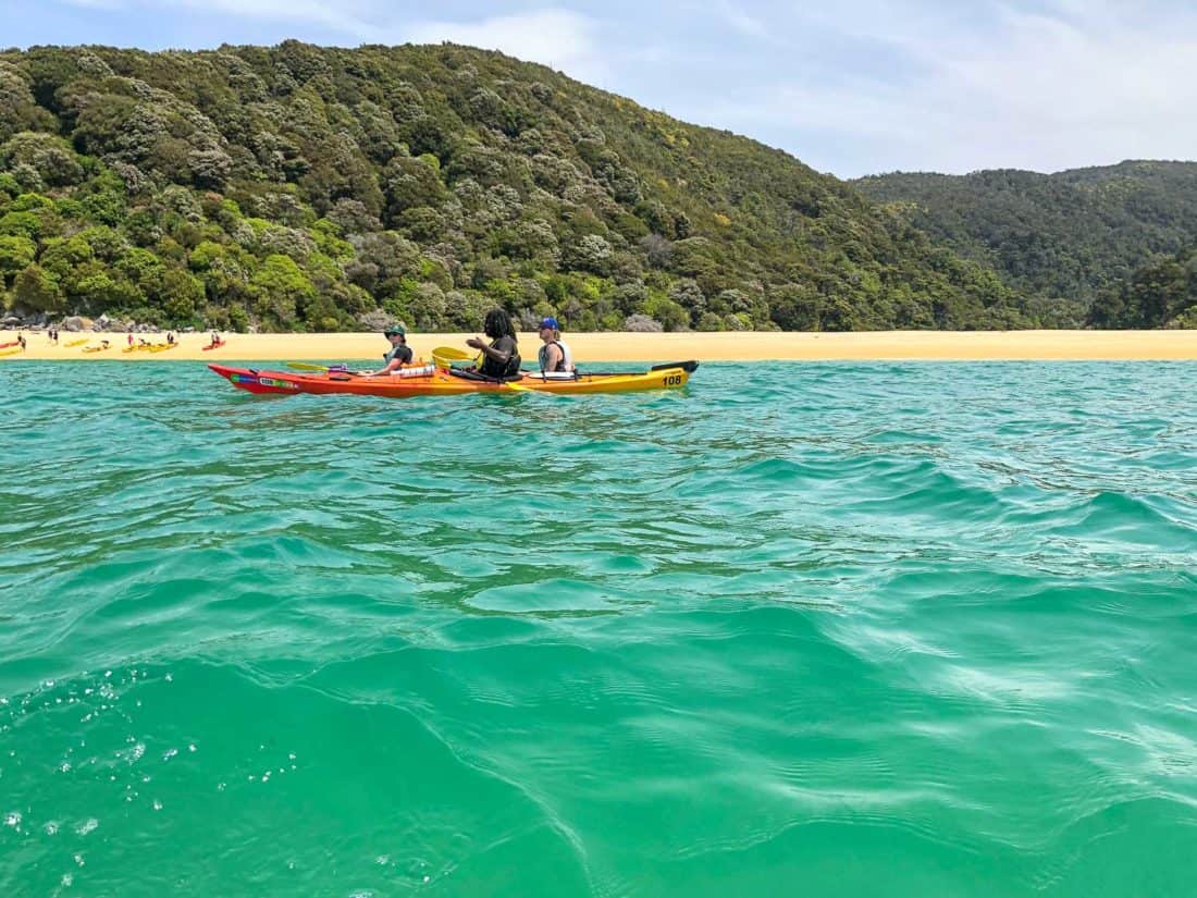 Kayaking past Sandfly Bay in Abel Tasman National Park, New Zealand