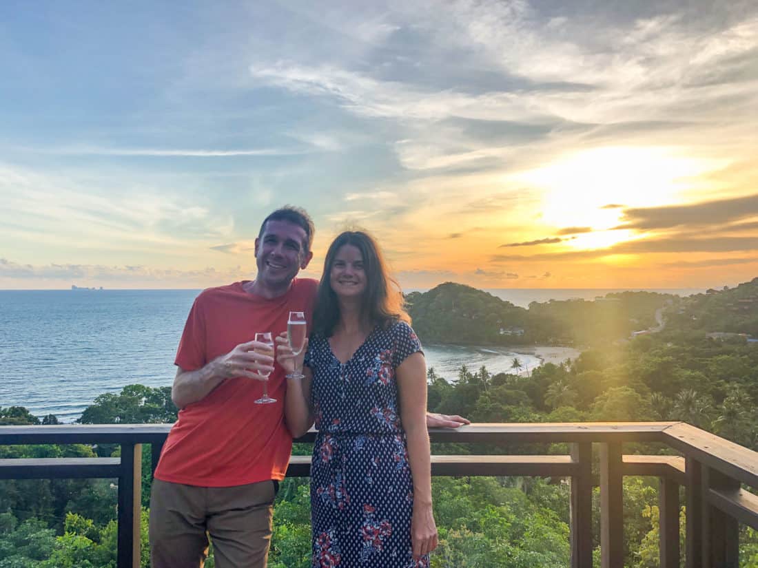 Simon and Erin celebrating anniversary with bubbly at sunset at Pimalai Resort, Koh Lanta