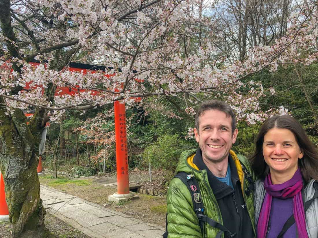 Simon and Erin at cherry blossom covered shrine in Kyoto