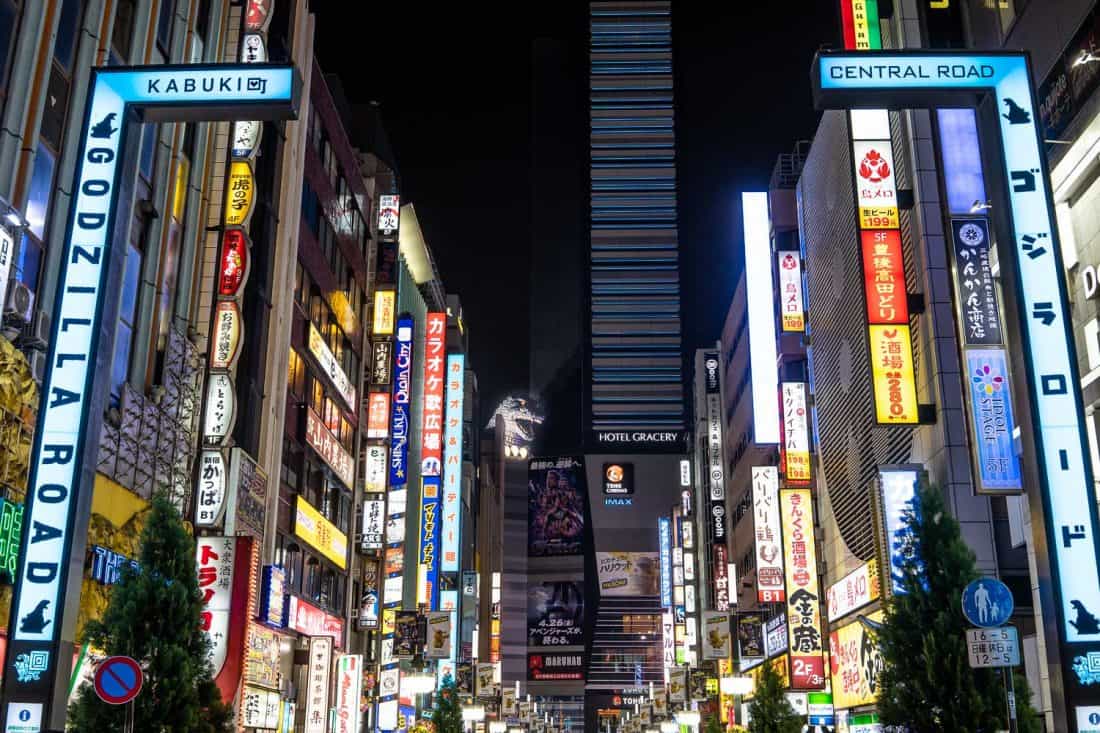 The Godzilla head at Hotel Gracery Shinjuku surrounded by the neon signs of the Shinjuku area of Tokyo