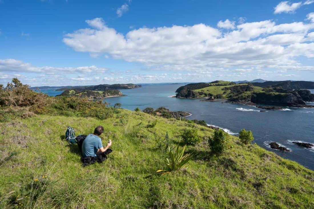 Eating lunch on the Cliff Pa Loop trail on Urupukapuka Island with views of Waewaetorea Island, Bay of Islands, NZ