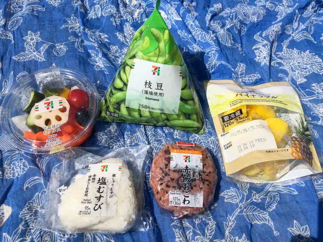 Vegetarian snacks at 7-Eleven Japan including onigiri, pickles, edamame, and pineapple