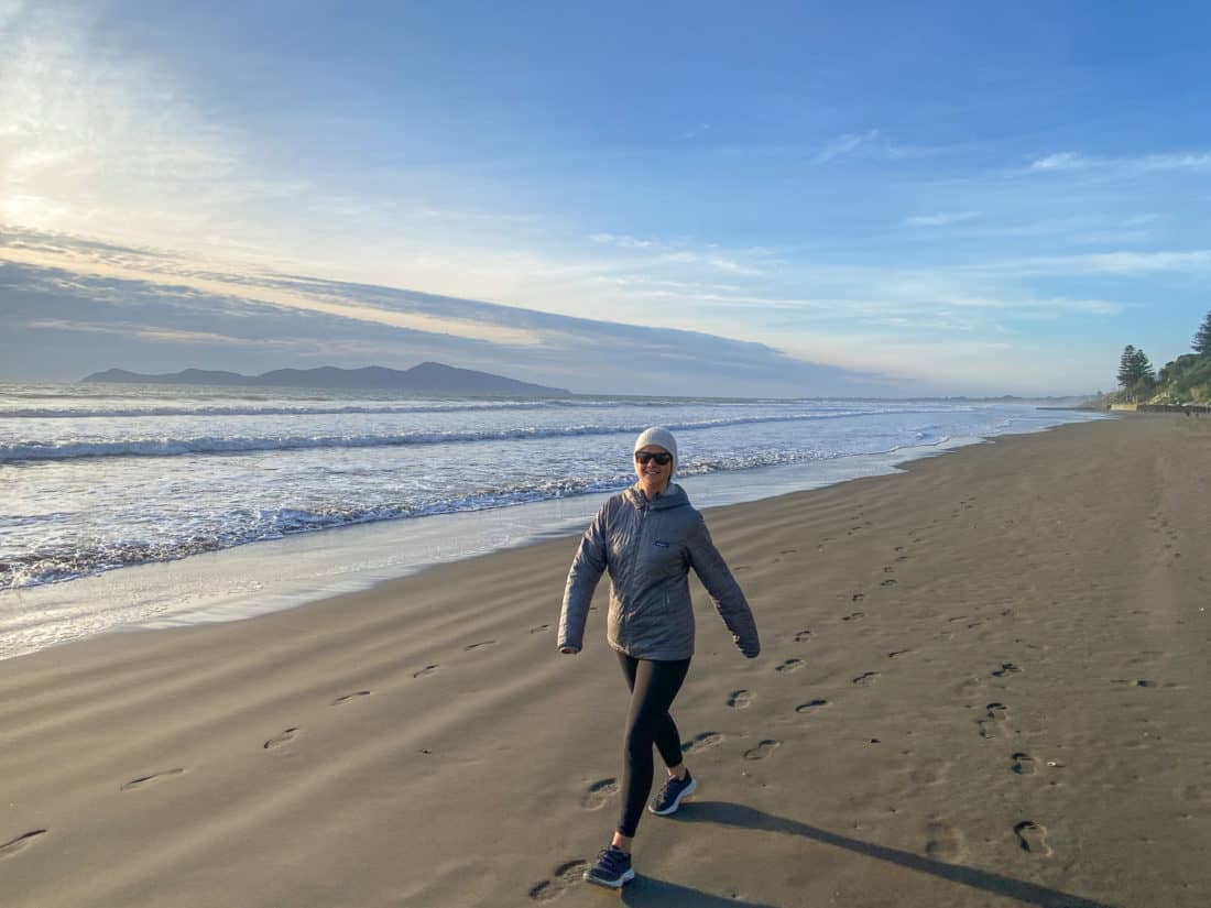 Erin walking on the beach in Allbirds Tree Dashers