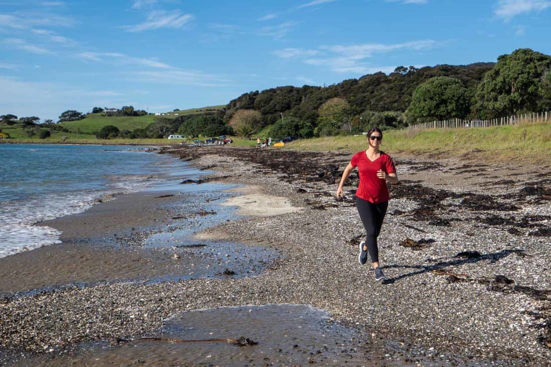 Erin running on the beach in Allbirds Dashers