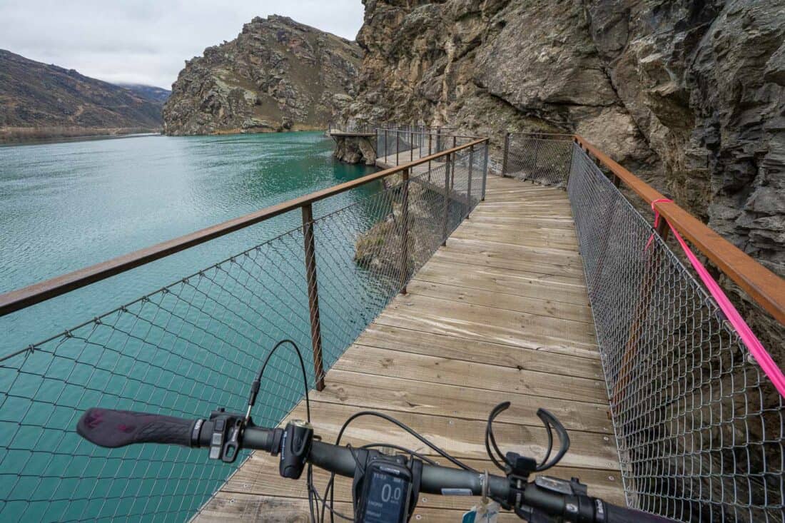 Cycling on a bolt on bridge on the Lake Dunstan Cycle Trail through Cromwell Gorge