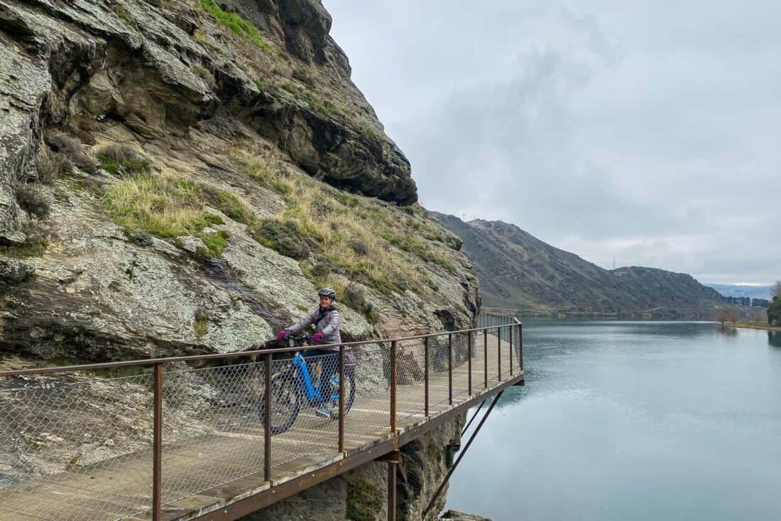 Cycling on a clip on bridge in the Cromwell Gorge section of the Lake Dunstan Cycle Trail