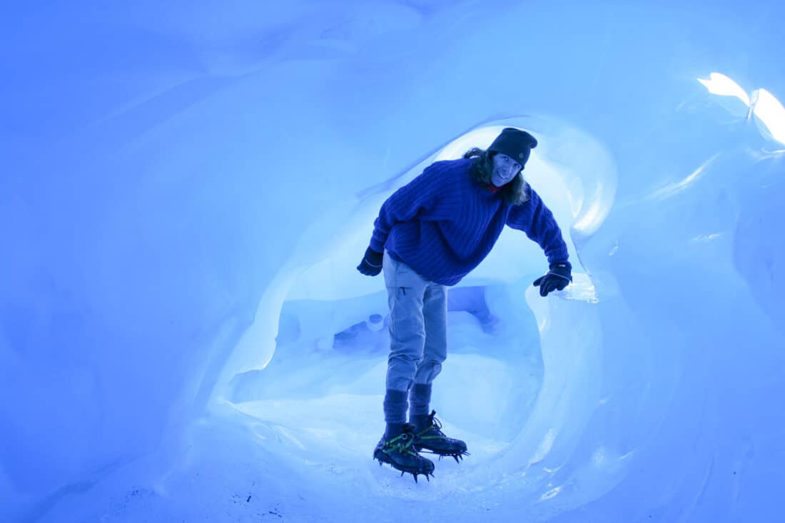Simon in a blue ice cave on a Fox Glacier Heli Hike, one of the top South Island activities in New Zealand