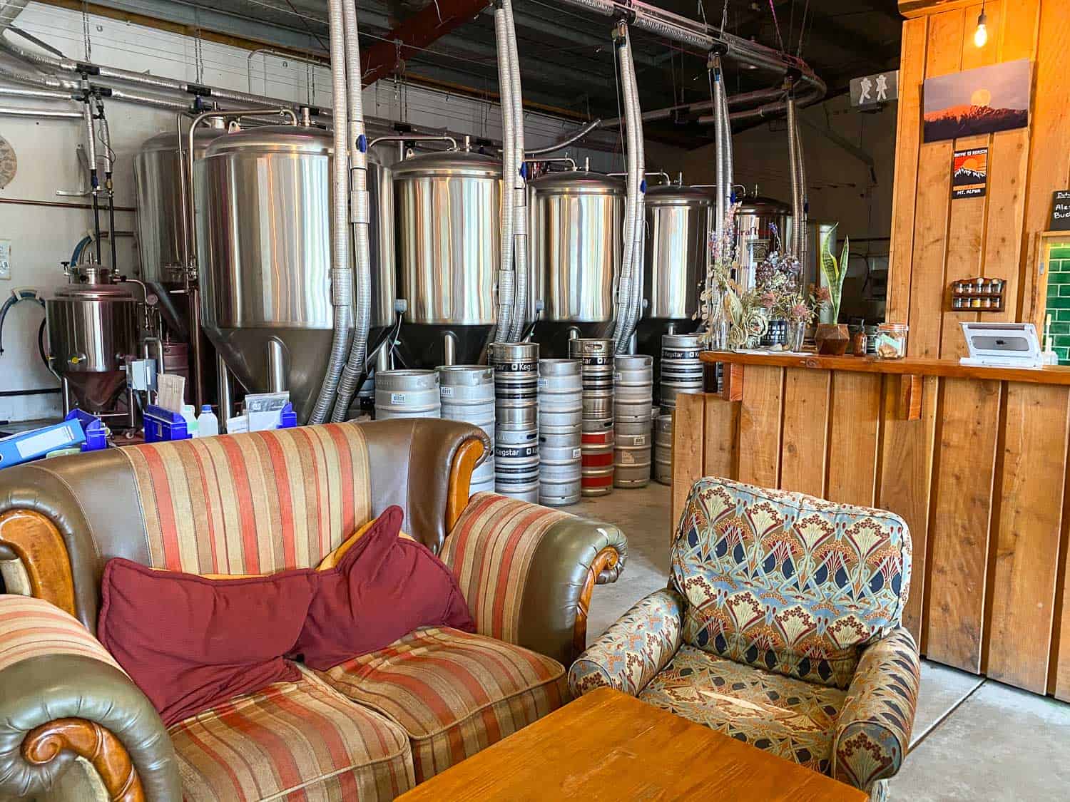 Kegs, bar and couches at Rhyme and Reason Brewery in Wanaka, New Zealand