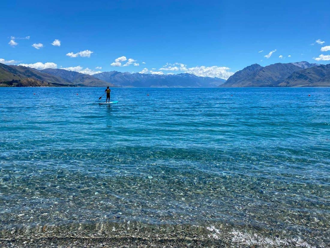 Simon stand up paddle boarding on Lake Hawea