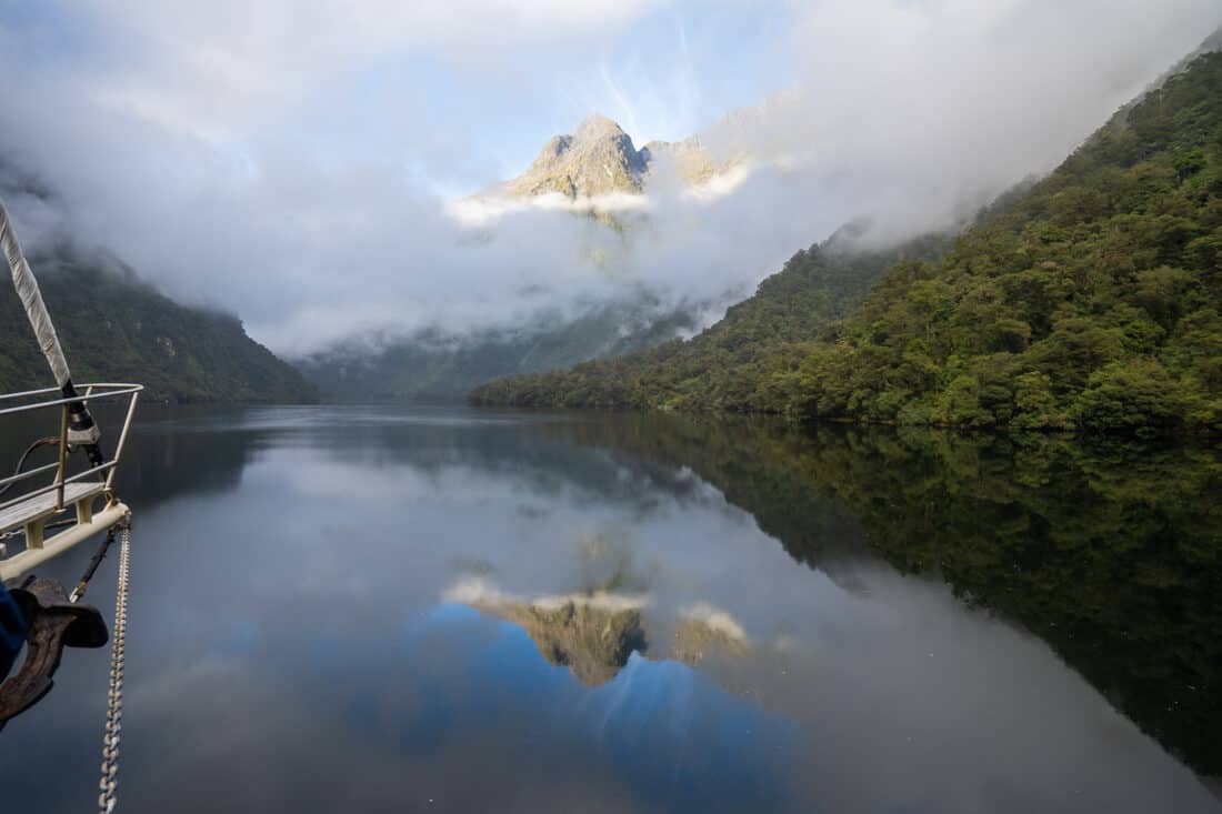 Misty early morning reflections on an overnight cruise in Doubtful Sound, New Zealand