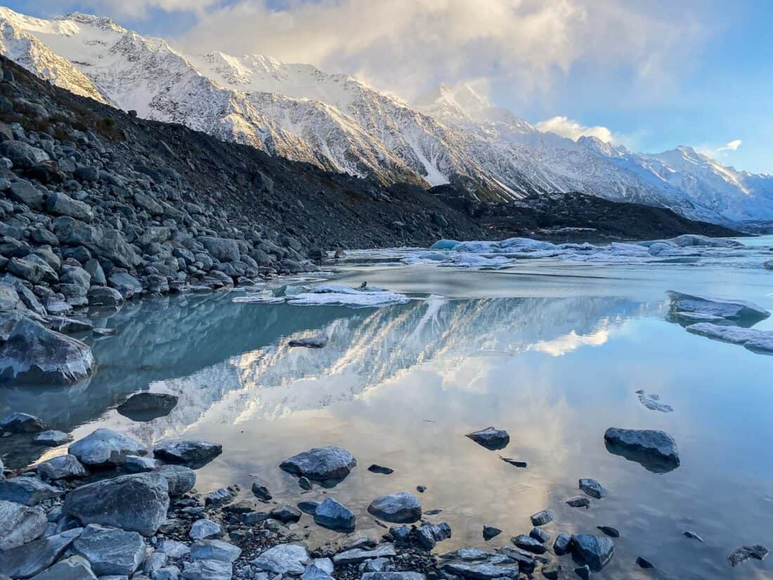 Sunrise reflections of Aoraki Mt Cook in Tasman Lake in winter, New Zealand