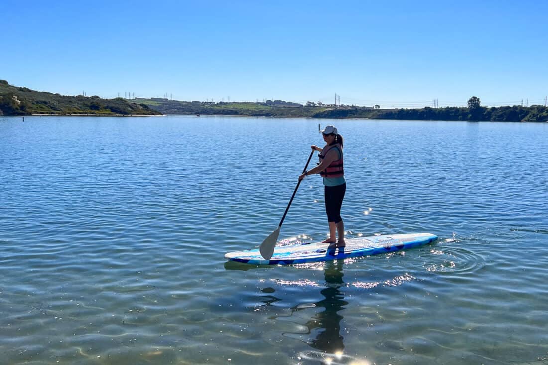 Standup paddleboarding at Agua Hedionda Lagoon is one of the most fun water activities in San Diego, California, USA