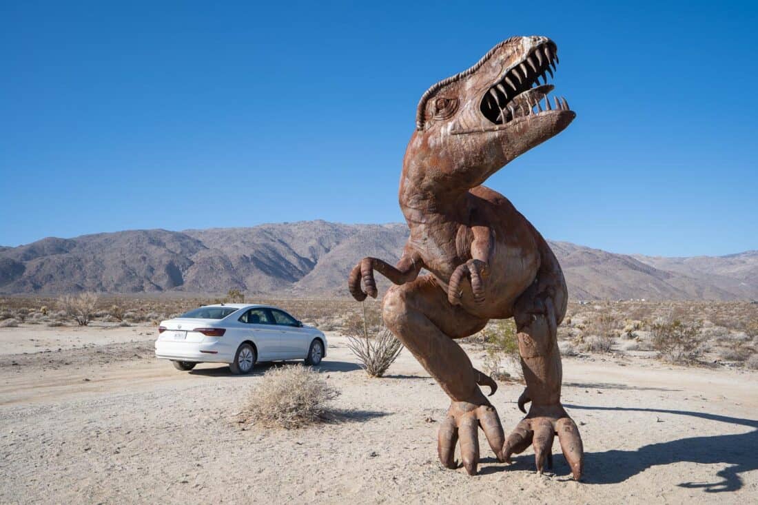 T-rex dinosaur sculpture in Borrego Springs next to a car