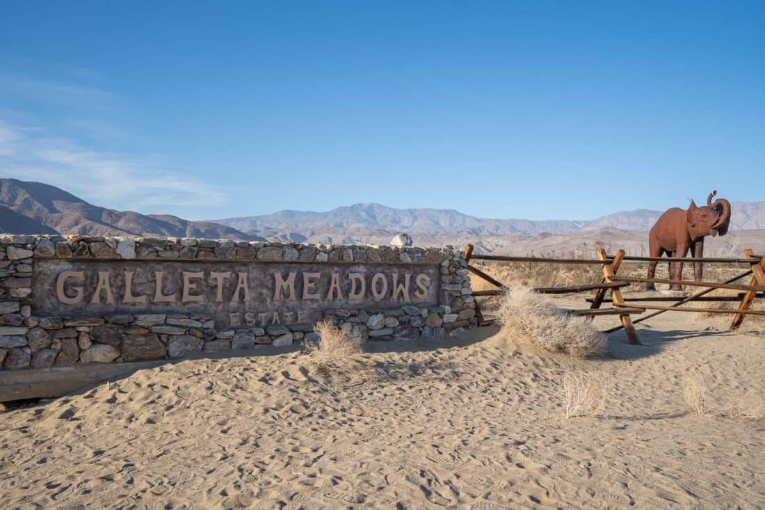 African elephant next to Galleta Meadows sign in Borrego Springs, California, USA