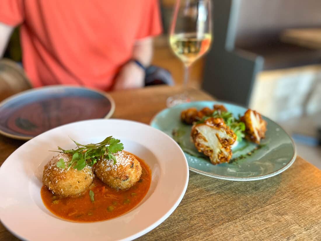 Vegan courgette and coconut arancini and cauliflower pakora at Wine and Reason vegetarian restaurant in Worthing