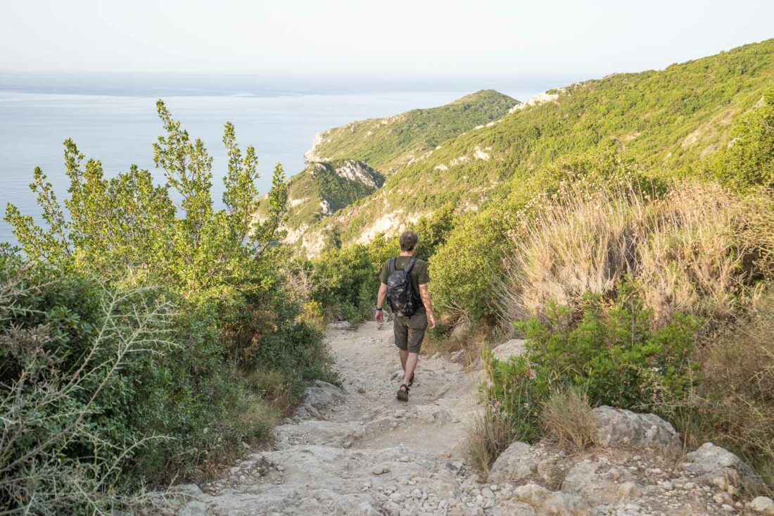 Walking the rocky trail to Porto Timoni beach Corfu