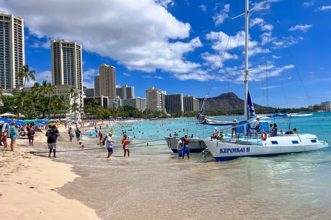Boat on Waikiki Beach, a must do destination on any Oahu itinerary