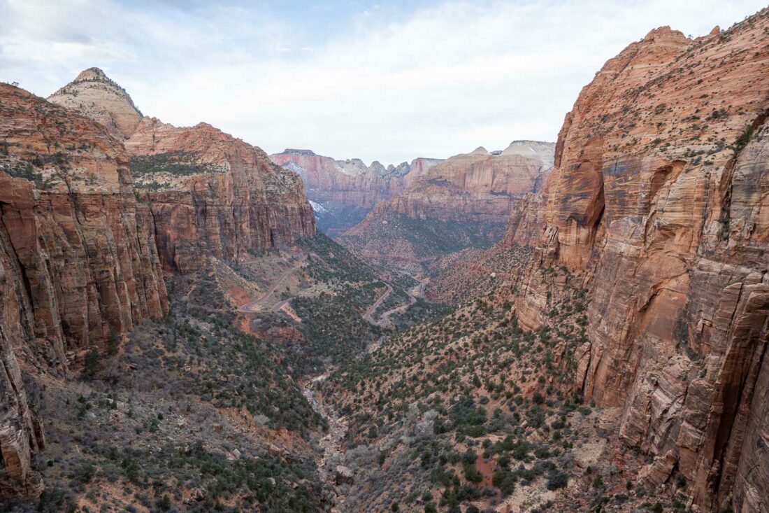 Panoramic view from Canyon Overlook with towering cliffs and winding road in Zion National Park, Utah
