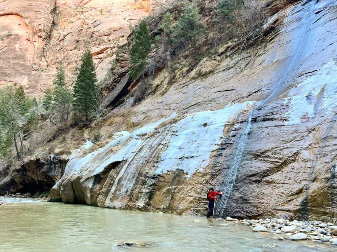 Simon admiring a frozen waterfall, The Narrows, Zion National Park, Utah, USA