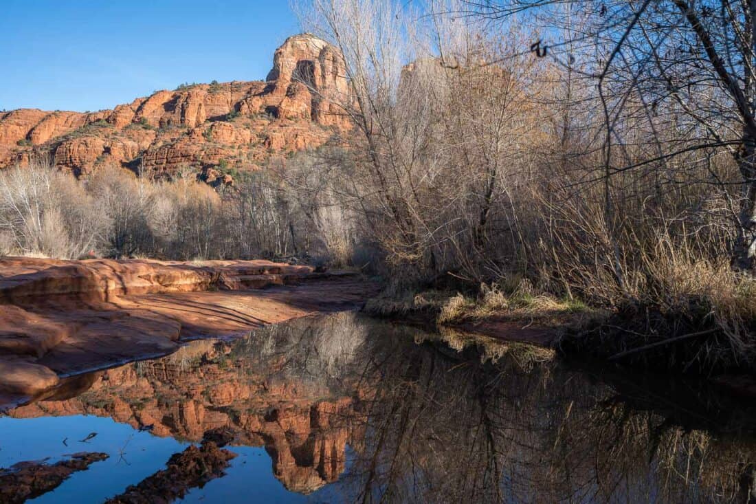 Red sandstone Cathderal Rock reflected in the water at Red Rock Crossing in Sedona, Arizona, USA