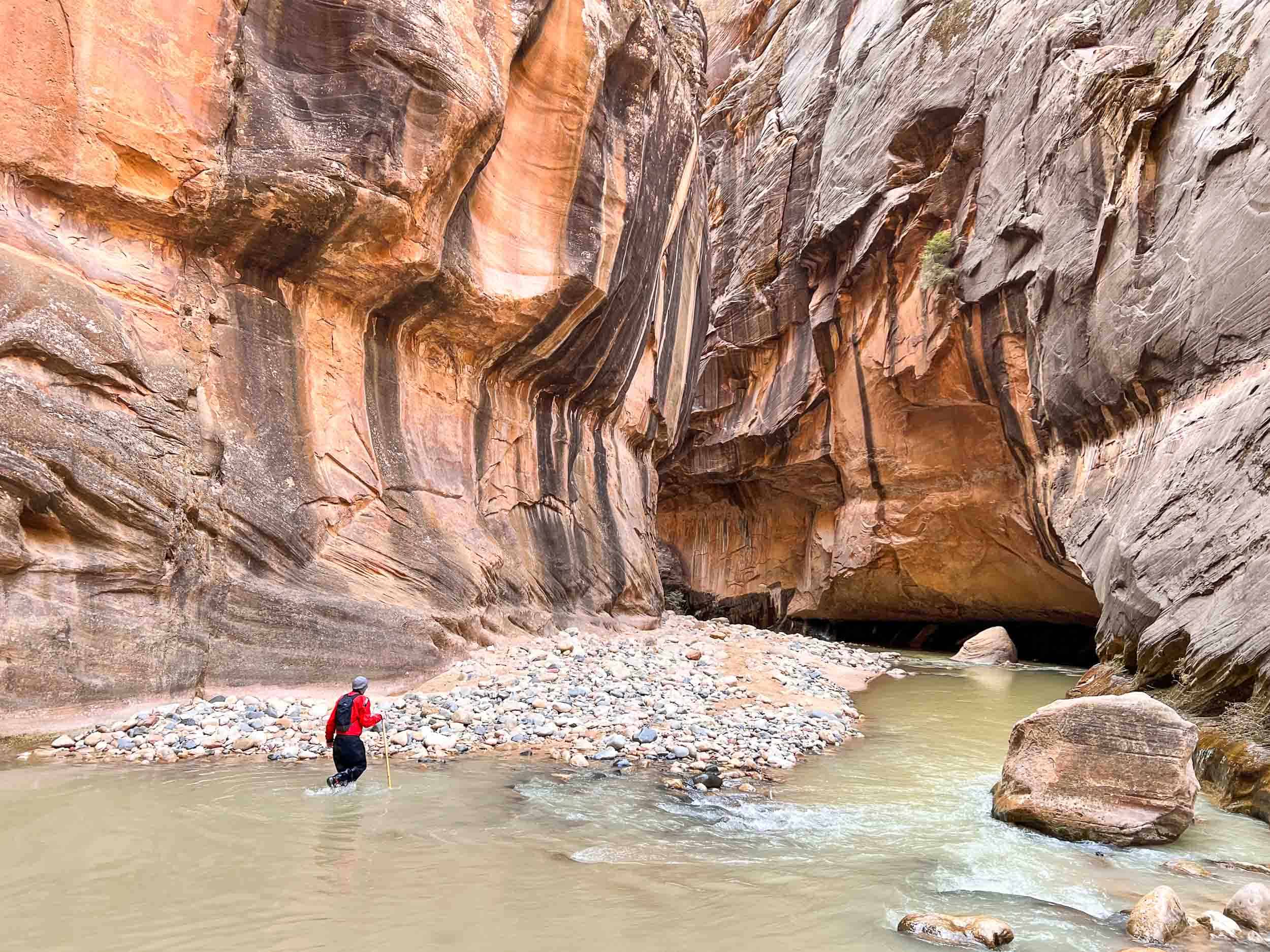 Hiking the Narrows in winter in Zion National Park wearing a dry suit