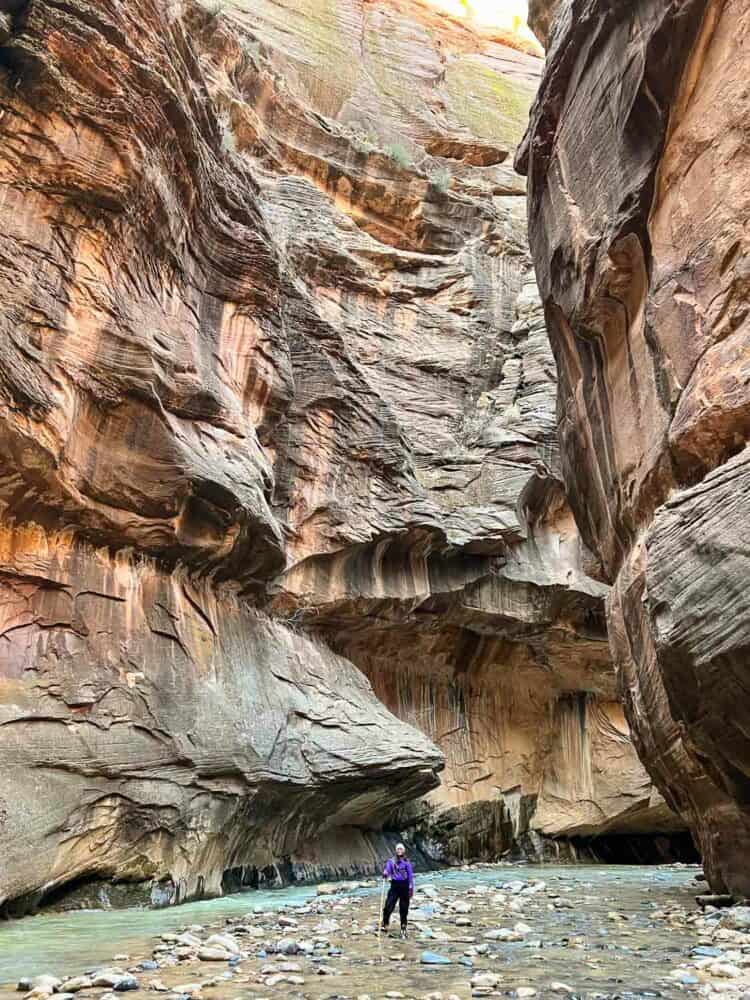 Erin in specialist watreproof hiking gear starting the Bottoms Up hiking trail, The Narrows, Zion National Park, Utah, USA 