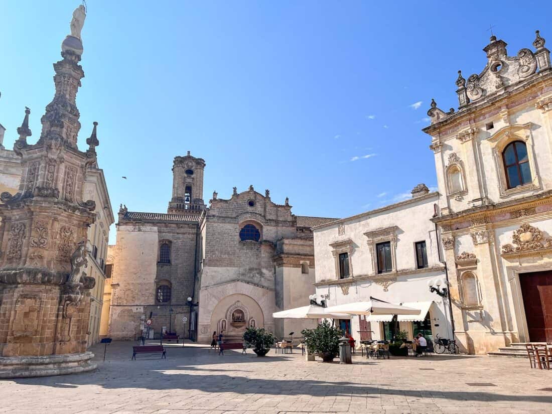 Grand fountain and church in Piazza Salandra on a sunny day, Nardo, Salento