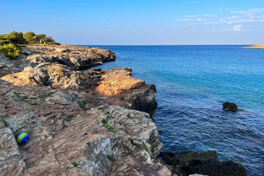 Rocky coastline and blue sea at Porto Selvaggio beach, Italy at sunrise