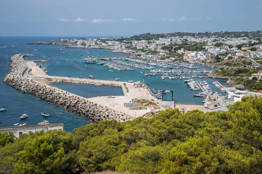 View from Santa Maria di Leuca lighthouse of the promenade below and boats moored in the marina, Salento