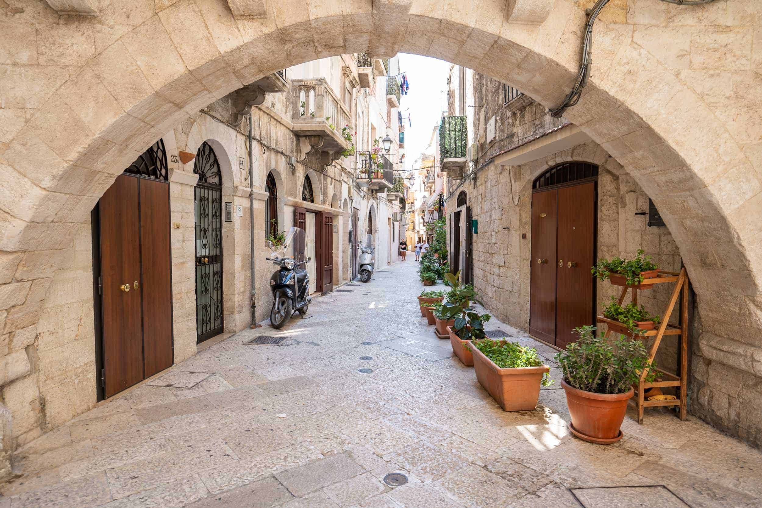 Stone archway in a narrow street of Bari Vecchia. Wandering here is one of the best things to do in Bari Italy.