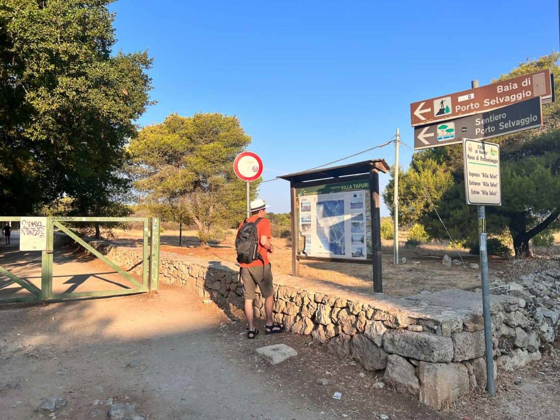 Simon looking at the notice board of the Villa Tafuri entrance to Porto Selvaggio Beach