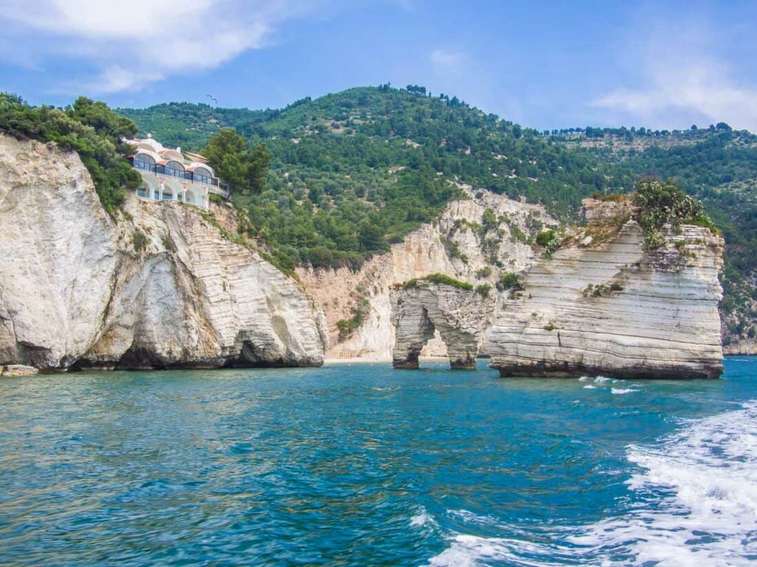 Dramatic white sea stacks and arch at Baia delle Zagare, Puglia