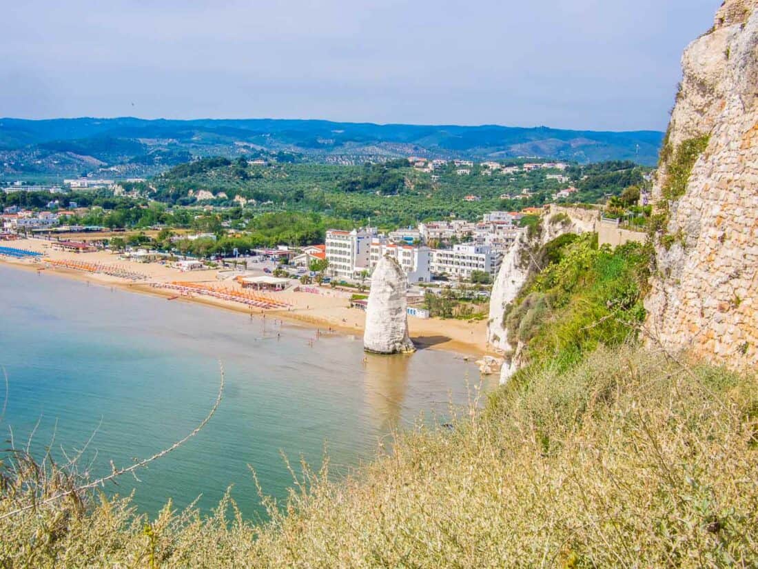 View from above of the towering white pillar of rock at Castle Beach, Vieste