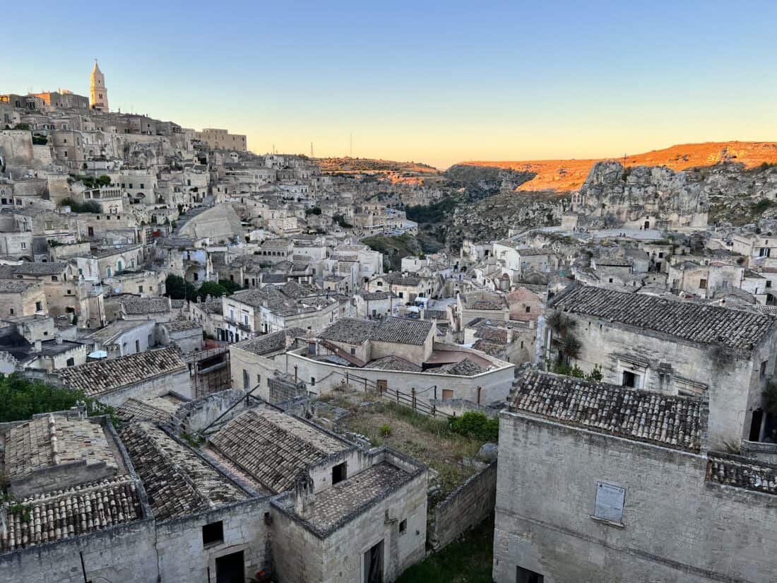 A sunset view from above of Matera with its windy streets and cave houses