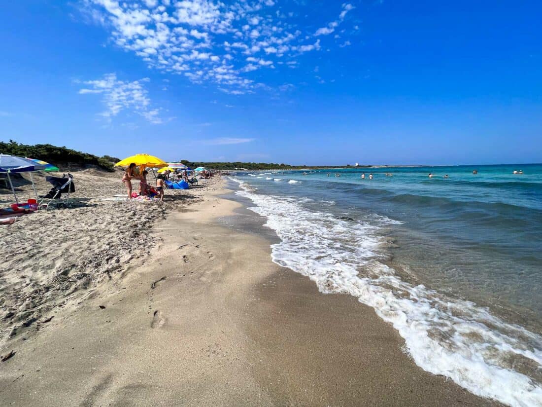 People enjoying the sun on the free beach at Punta Pizzo, Puglia