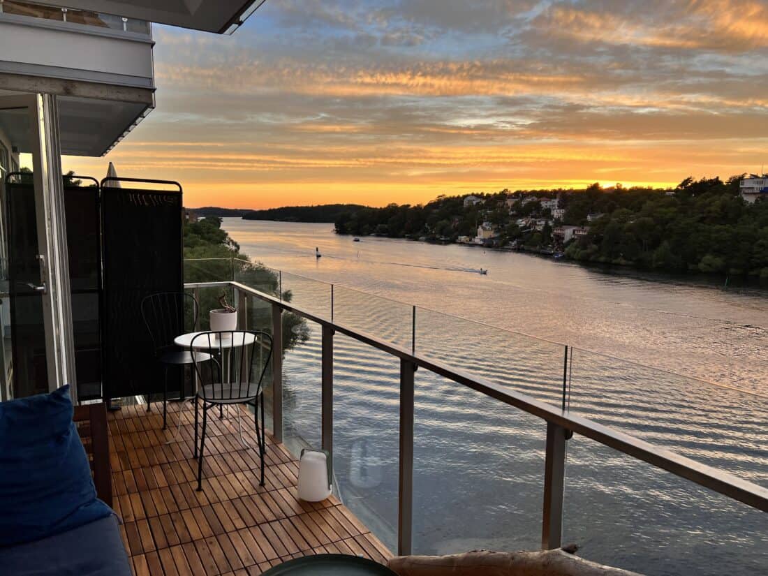 A view from our Airbnb balcony in Sweden at sunset, overlooking one of the many lakes