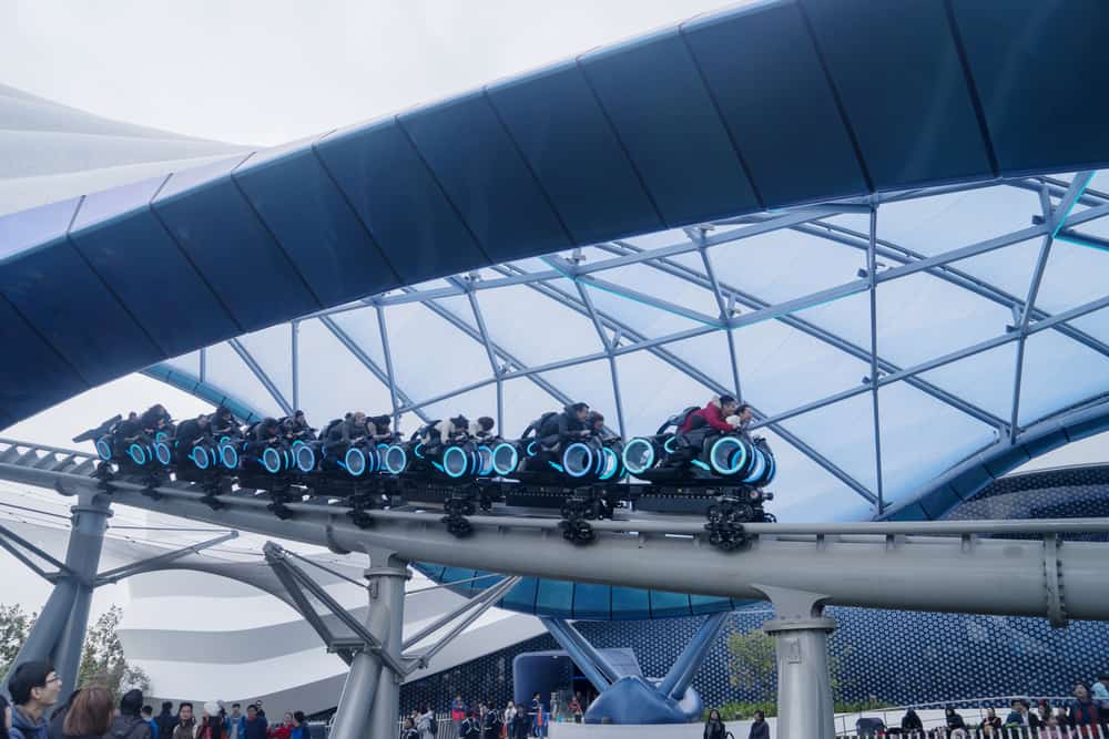 People ride TRON Lightcycle in Shanghai Disneyland