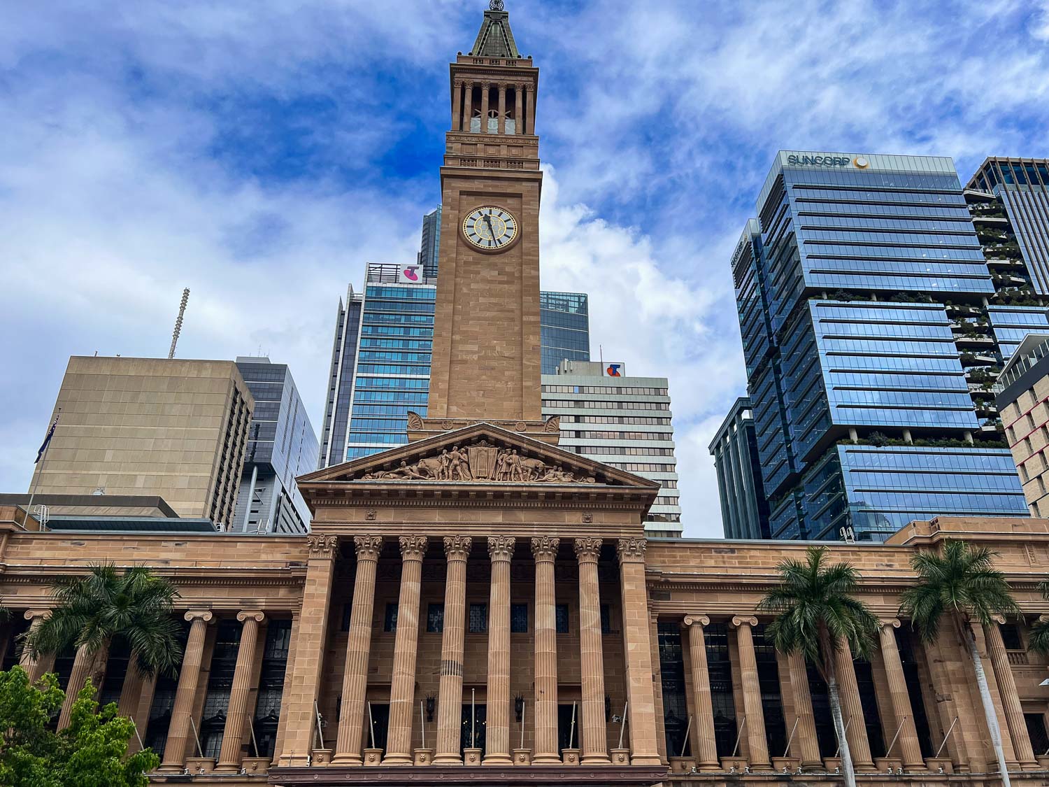 Grand columns and a large clocktower at Brisbane City Hall, Australia