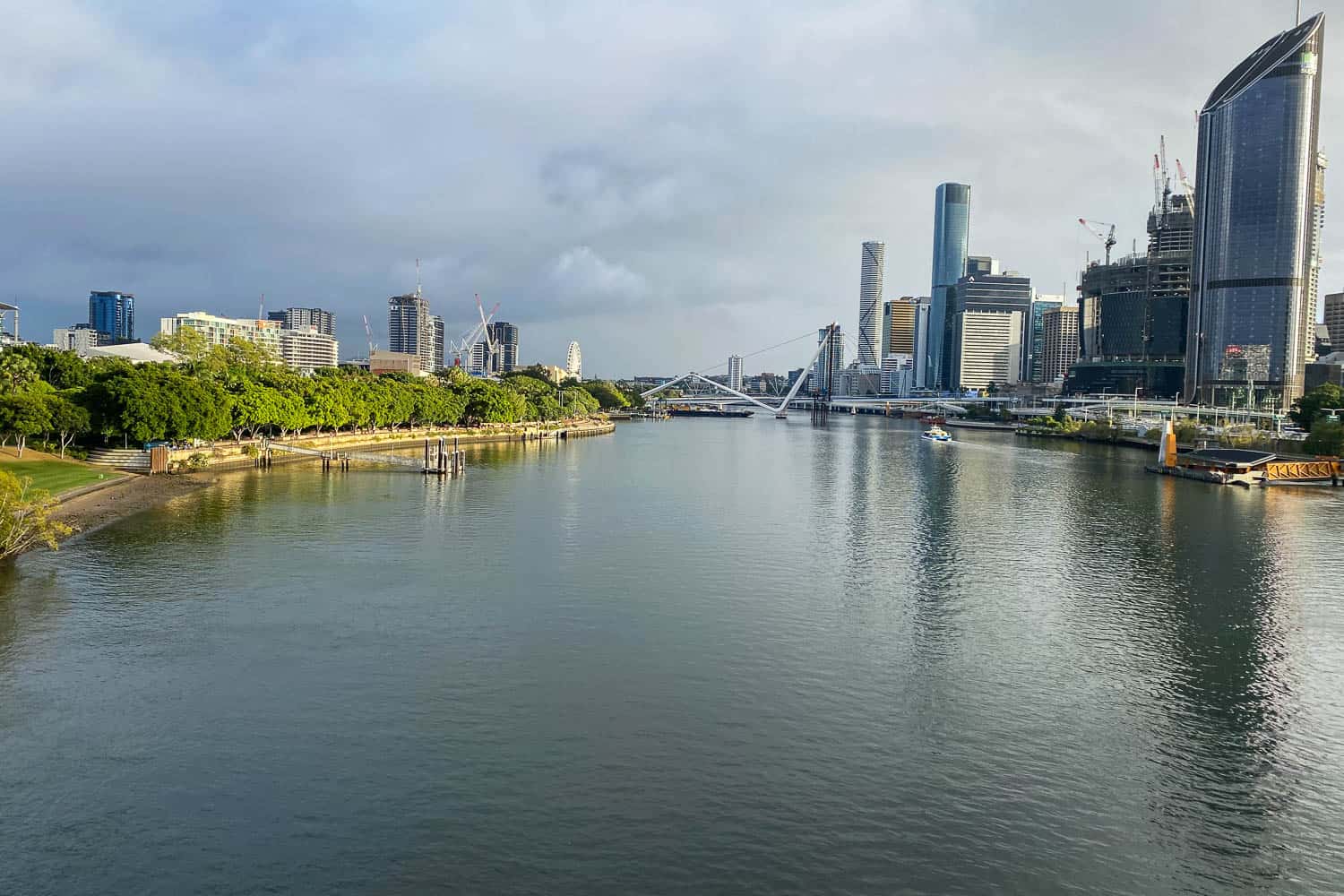 Lush greenery, wide Brisbane river and cityscape in the Southbank, Brisbane, Australia