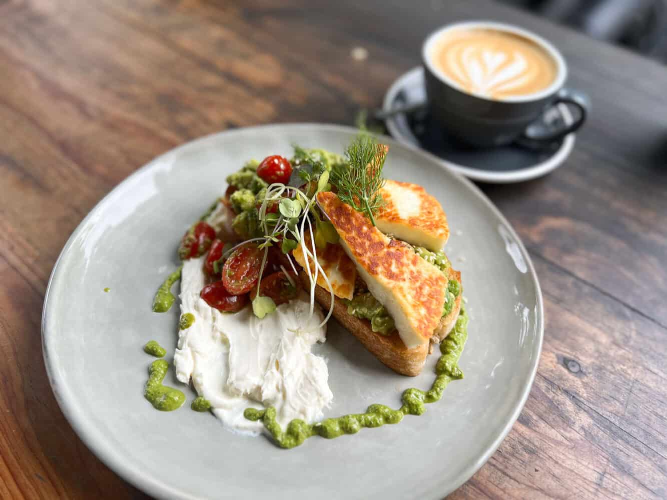 Avocado toast with halloumi and labneh at Moto cafe, Noosa, Queensland, Australia 