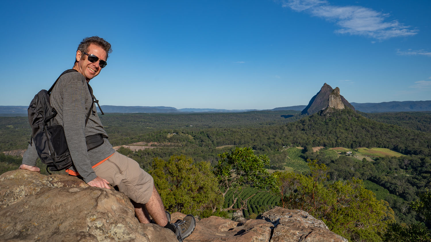 Simon on top of Mt Ngungun overlooking the Glasshouse Mountains, Sunshine Coast Hinterland, Queensland, Australia