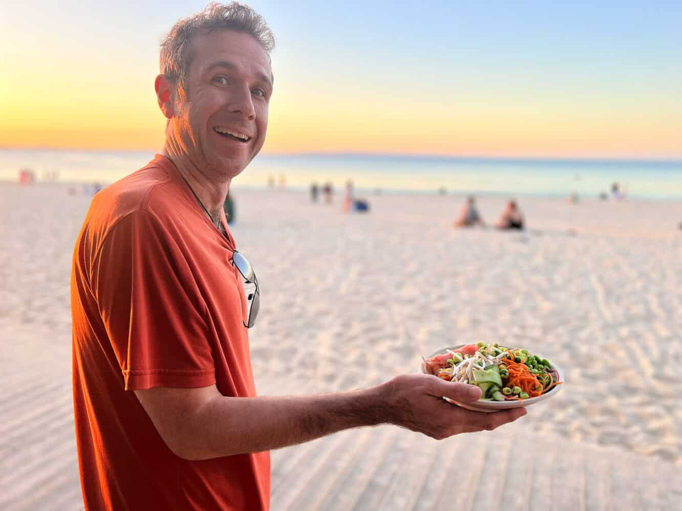 Simon taking his Raw+Rice poke bowl to the beach, Noosa, Queensland, Australia