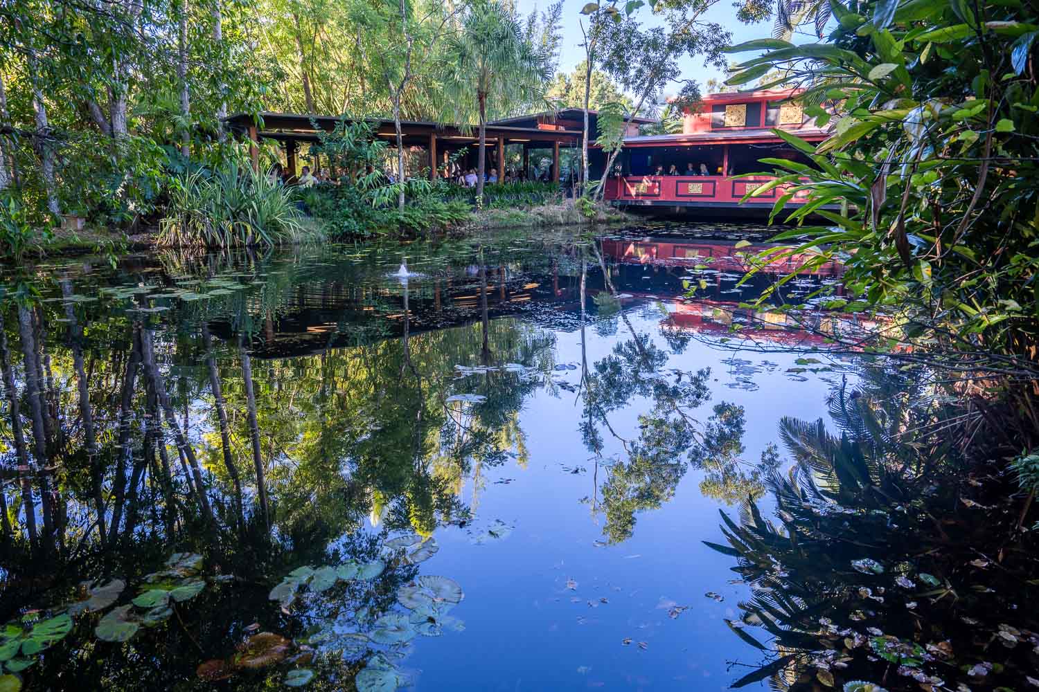 Spirit House restaurant reflected in a picturesque pond and lush greenery, Sunshine Coast Hinterland, Queensland, Australia