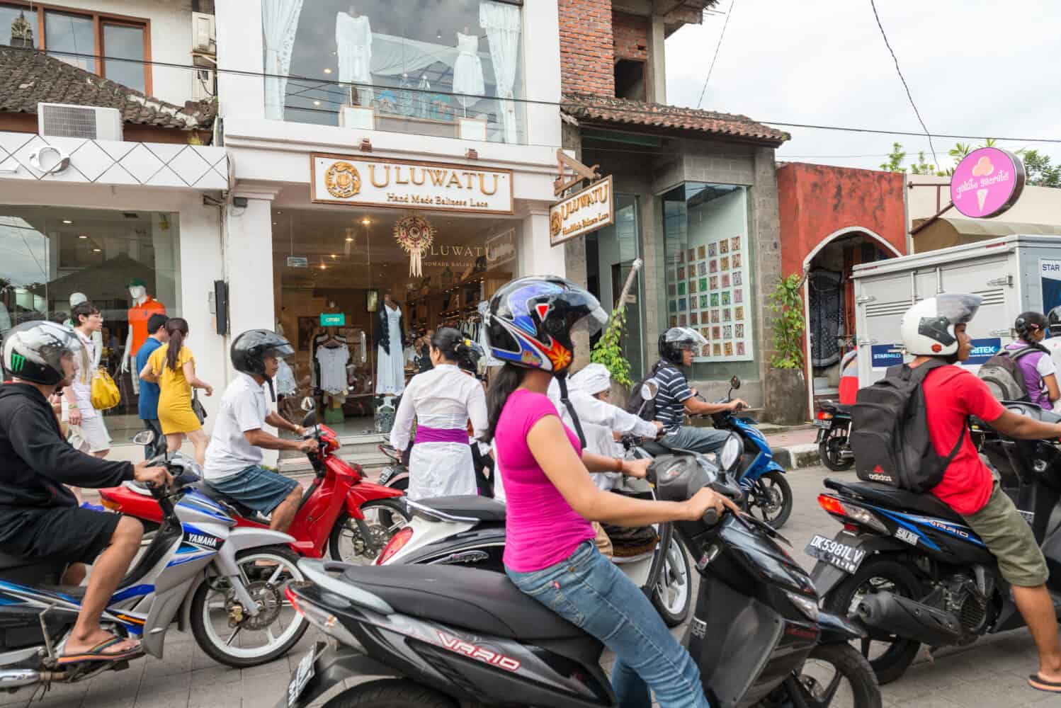 People ride motorbikes at main commercial street, Ubud, Bali