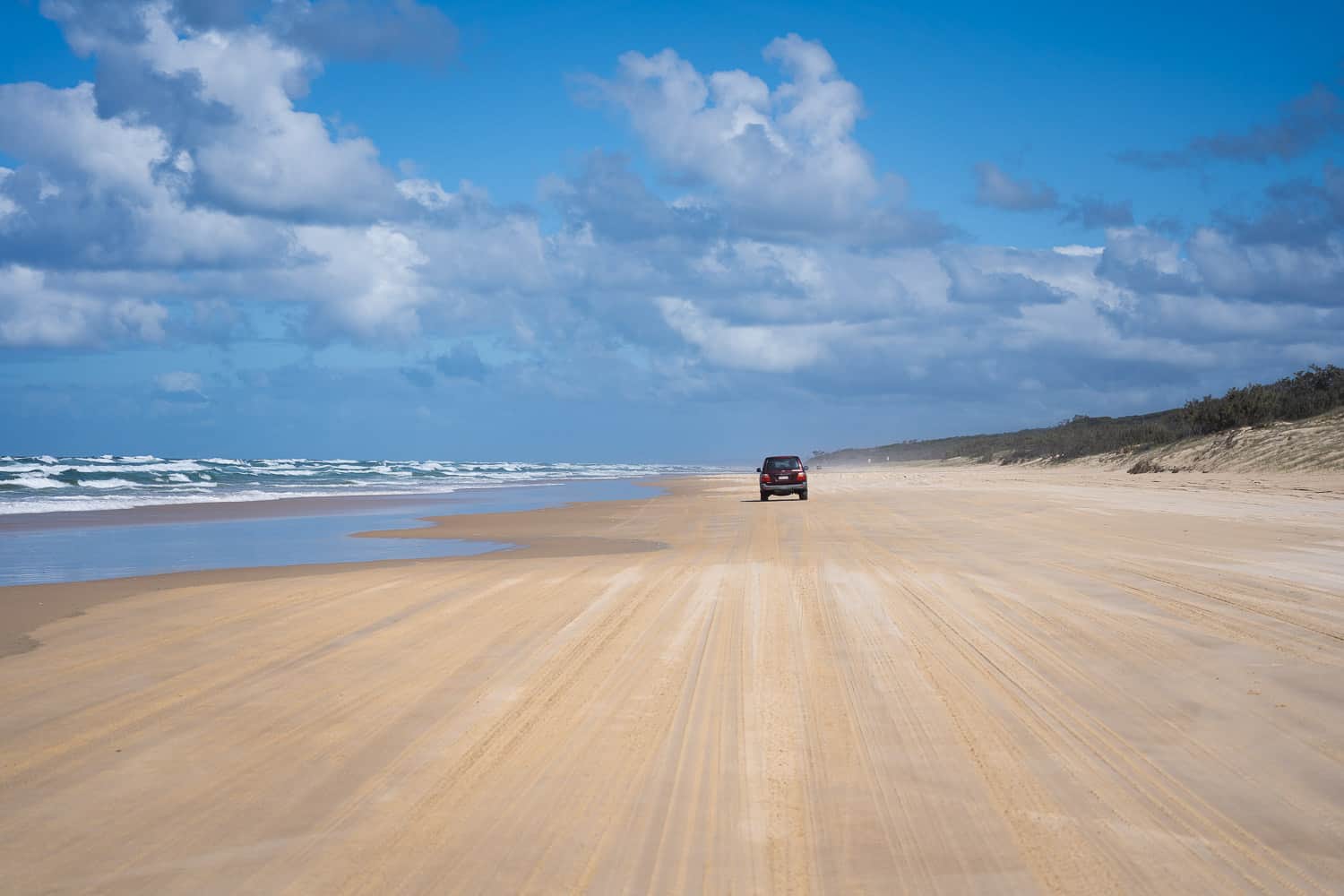 Driving along 75 Mile Beach, K'gari, Queensland, Australia