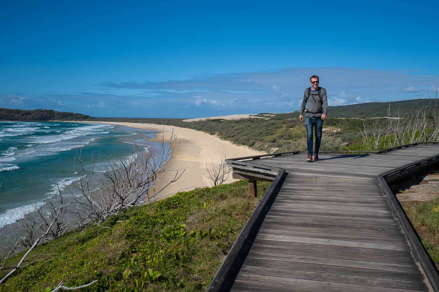 Simon walking along the boadwalk path to Champagne Pools, K'gari, Queensland, Australia