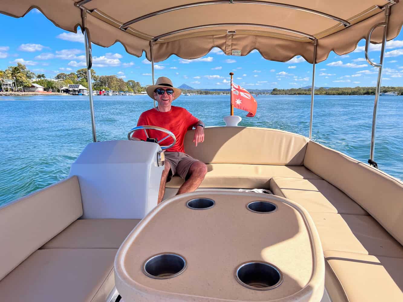 Simon in a hire boat, Noosa River, Queensland, Australia