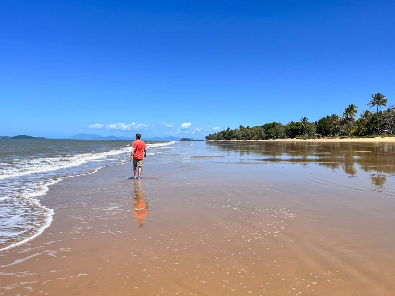 Simon strolling along sandy Mission Beach, North Queensland, Australia